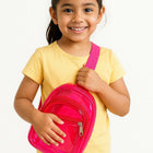 Young girl holding a pink backpack against a white background