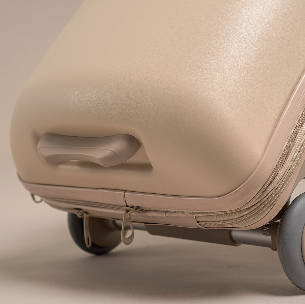 Beige suitcase with wheels on a beige background