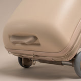 Beige suitcase with wheels on a beige background