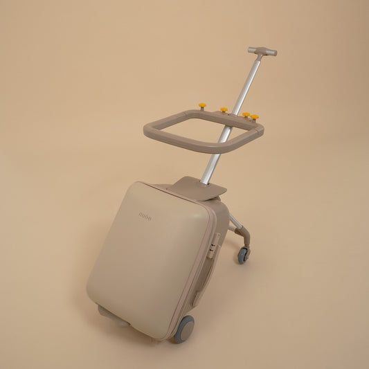 Beige suitcase with a built-in trolley on a beige background