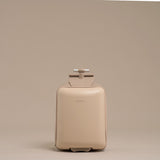 Beige suitcase with a handle on a beige background