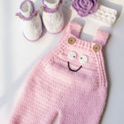 Pink knitted baby romper white booties, and purple flower 