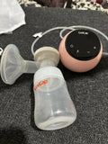 LUVLAP Adore Rechargeable Electric Breast Pump with 2 Phase Pumping in Almost New condition, featuring adjustable pumping settings, comfortable breast cushion, rechargeable operation, and a convenient design for everyday breast milk expression.