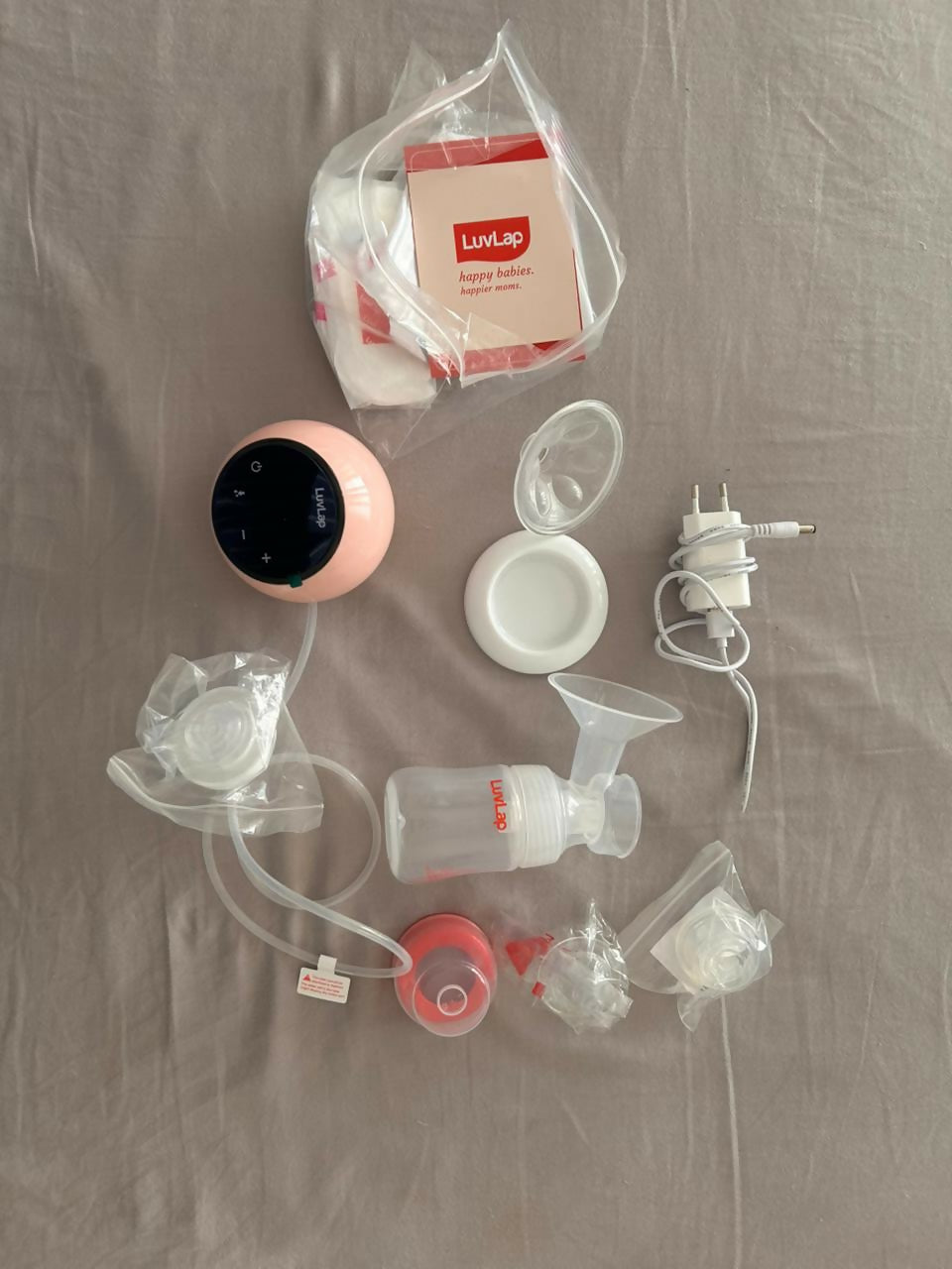 LuvLap Adore electric breast pump with adjustable suction, compact design, milk collection bottle, and comfortable pumping support for breastfeeding mothers.