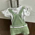 Children's outfit with white shirt and green overalls 
