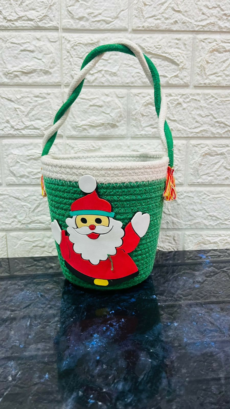 Green woven basket with a Santa Claus design
