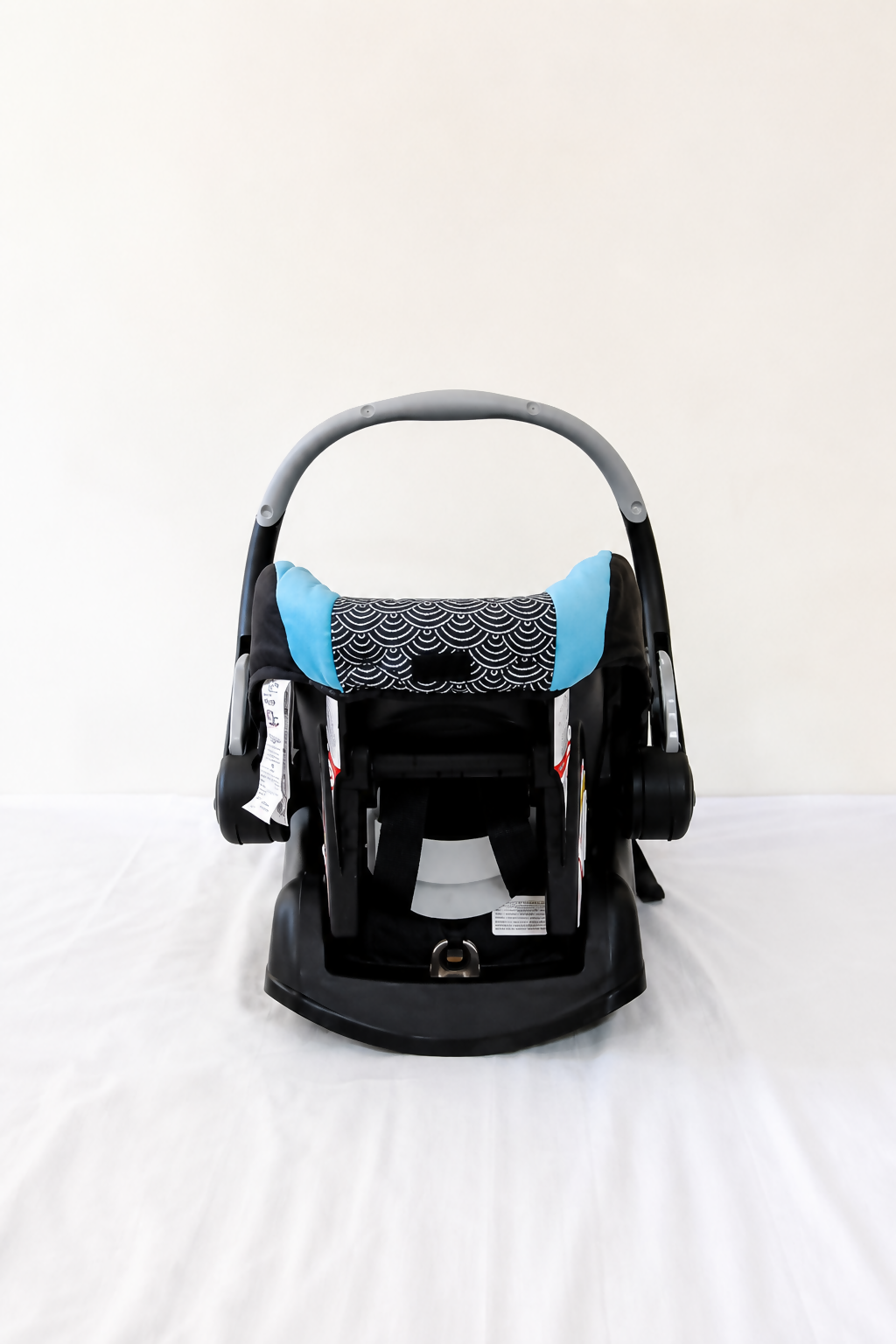 Evenflo Embrace infant car seat with base, rear-facing design, cushioned newborn support, secure safety harness, and portable baby carrier functionality for safe travel.