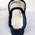 babycab Noah Carrycot Bassinet in Navy Blue, designed as a stroller attachment with a comfortable padded interior, protective canopy, sturdy construction, and cozy lie-flat space for newborns and young infants.