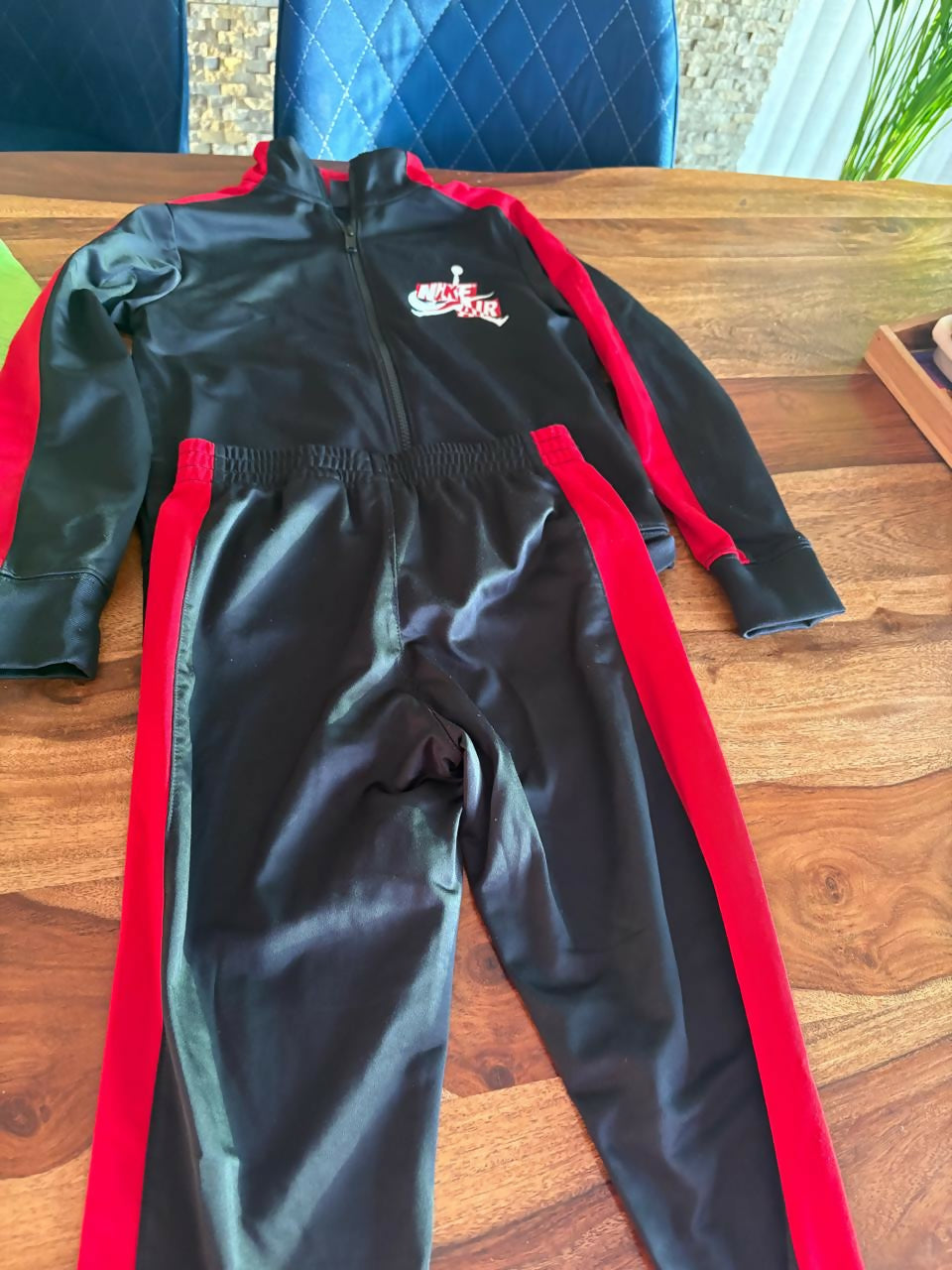 Nike Air trackpant set for kids featuring a coordinated sweatshirt and trackpants, comfortable fabric, sporty design, and everyday wear suitable for play, outings, and casual activities.