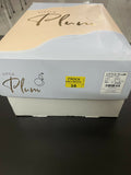 Box with 'Little Plum' branding on a dark surface