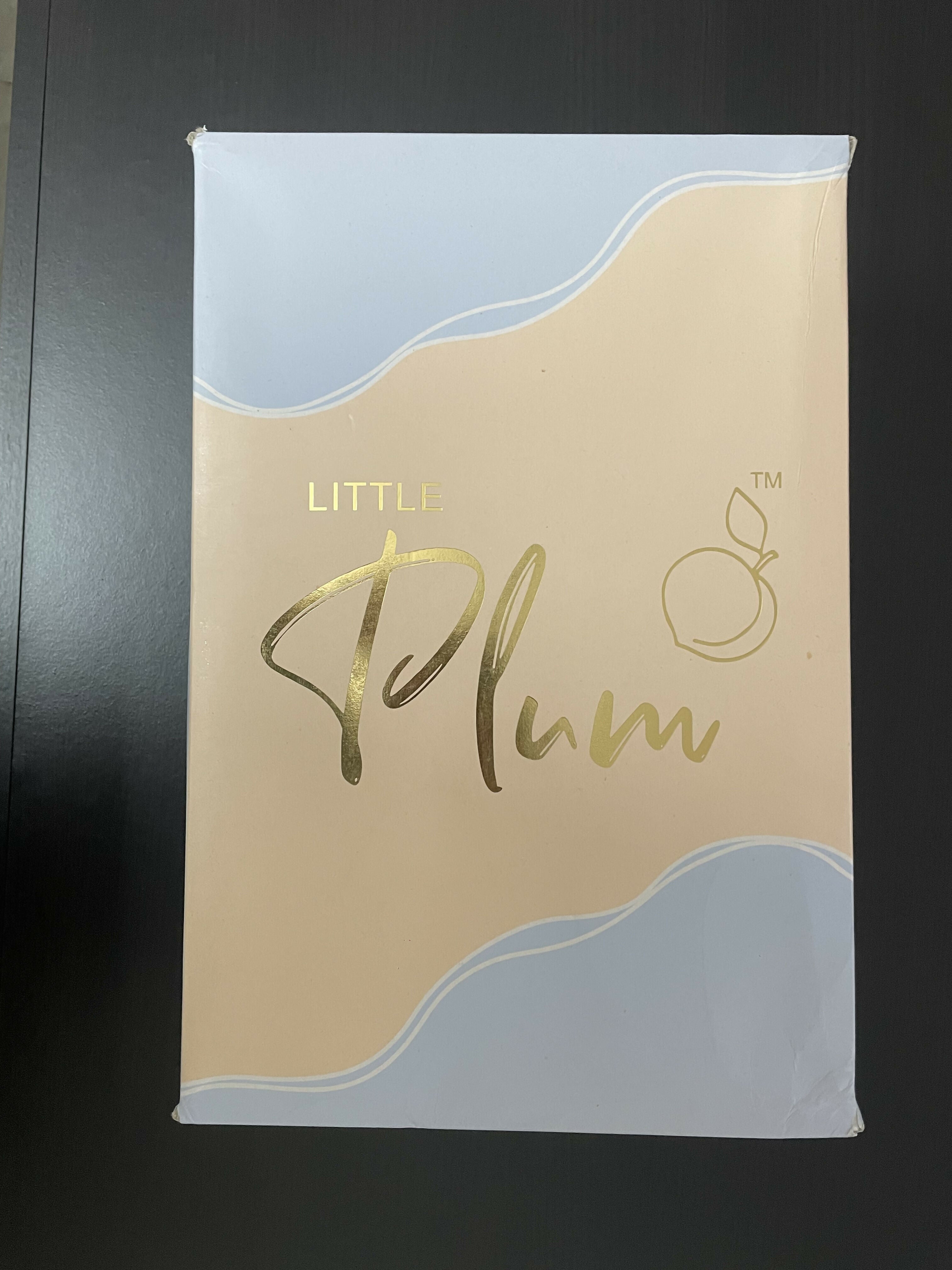 Packaging with 'Little Plum' branding on a dark background