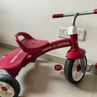 RADIO FLYER tricycle with sturdy construction, comfortable seat, easy-grip handlebars, smooth wheels, and child-friendly design for outdoor play and riding adventures.