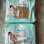 Pampers Baby Diaper Combo with 2 packs of 70 diapers each, featuring soft breathable materials, high absorbency, leak protection, stretchy waistband, and a comfortable fit for babies.