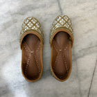 Golden Punjabi Jutti with decorative mirror work detailing for festive and traditional outfits.