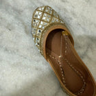 Golden Punjabi Jutti with decorative mirror work detailing for festive and traditional outfits.
