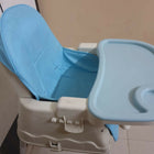 Blue and beige baby high chair with tray on a plain background