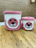 Two pink and white woven baskets with bear face designs 