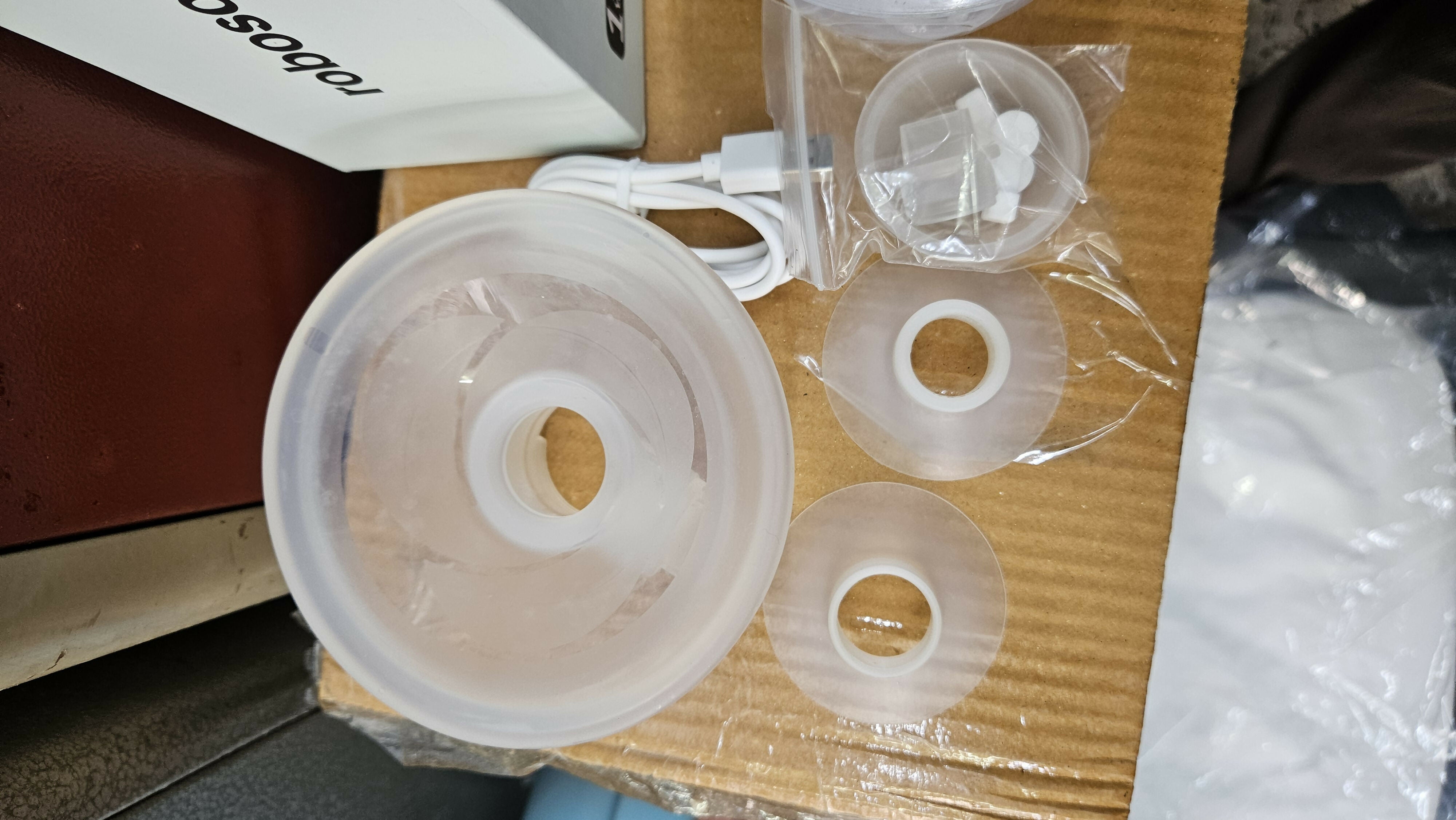ROBOSON wearable breast pump with hands-free design, compact milk collection cups, adjustable suction settings, and portable pumping support for breastfeeding mothers.