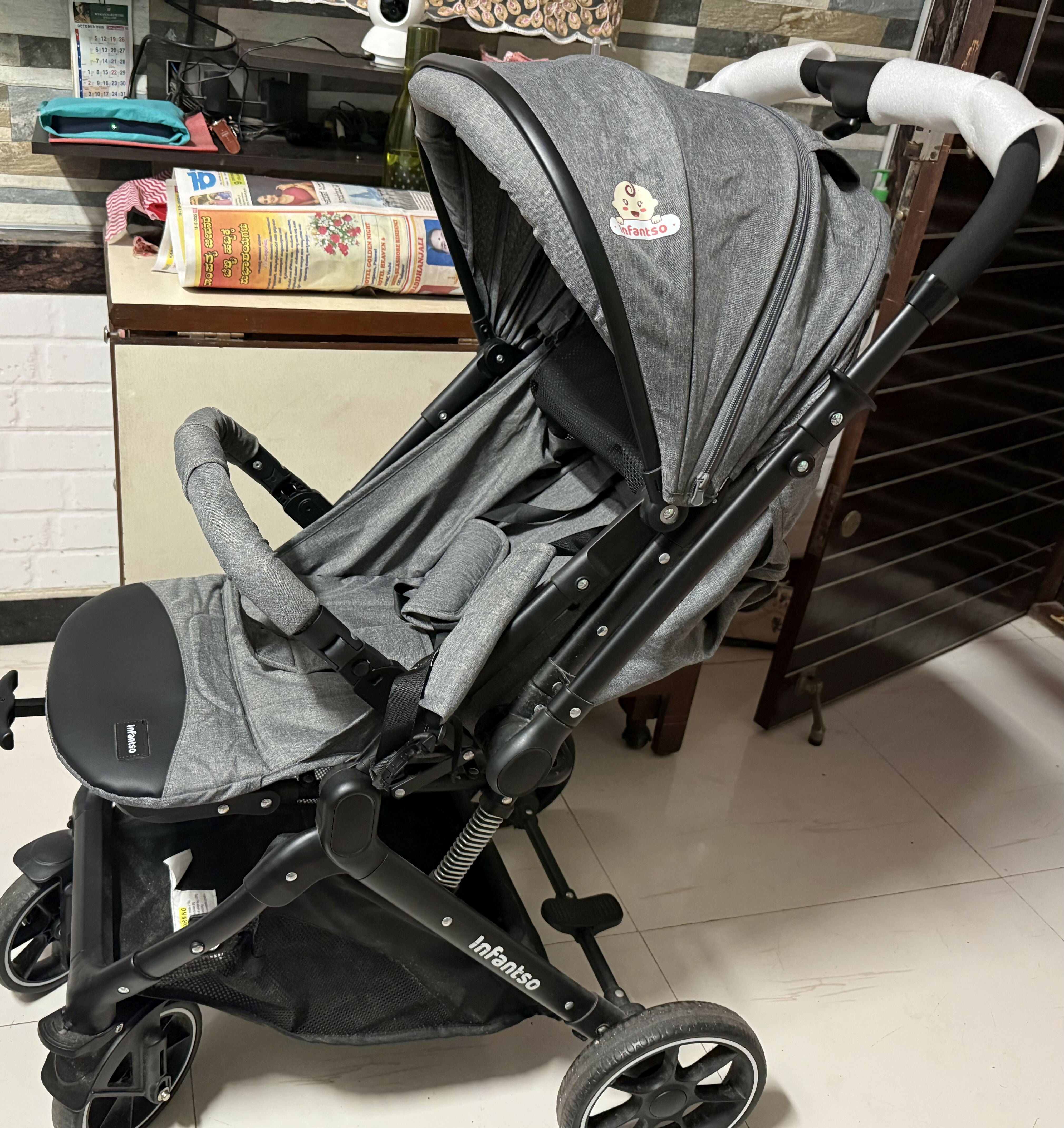 Gray stroller with black accents on a tiled floor