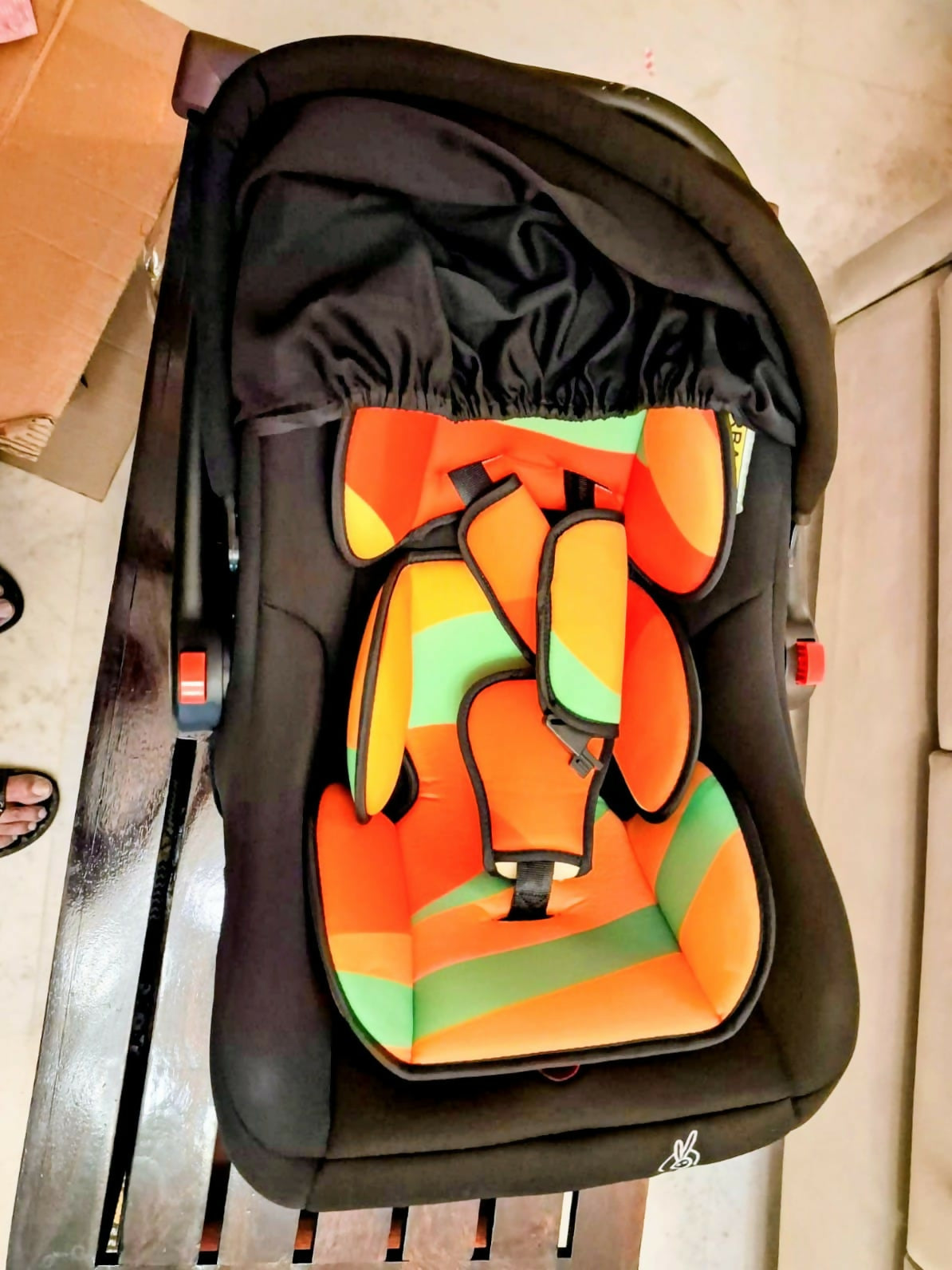 R for Rabbit Picaboo infant car seat with rear-facing design, cushioned seating, secure safety harness, ergonomic carry handle, and protective side support for safe and comfortable travel with newborns and infants.