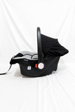 R for Rabbit Picaboo infant car seat carrier with rear-facing design, cushioned newborn support, secure safety harness, carry handle, and comfortable travel protection for babies.