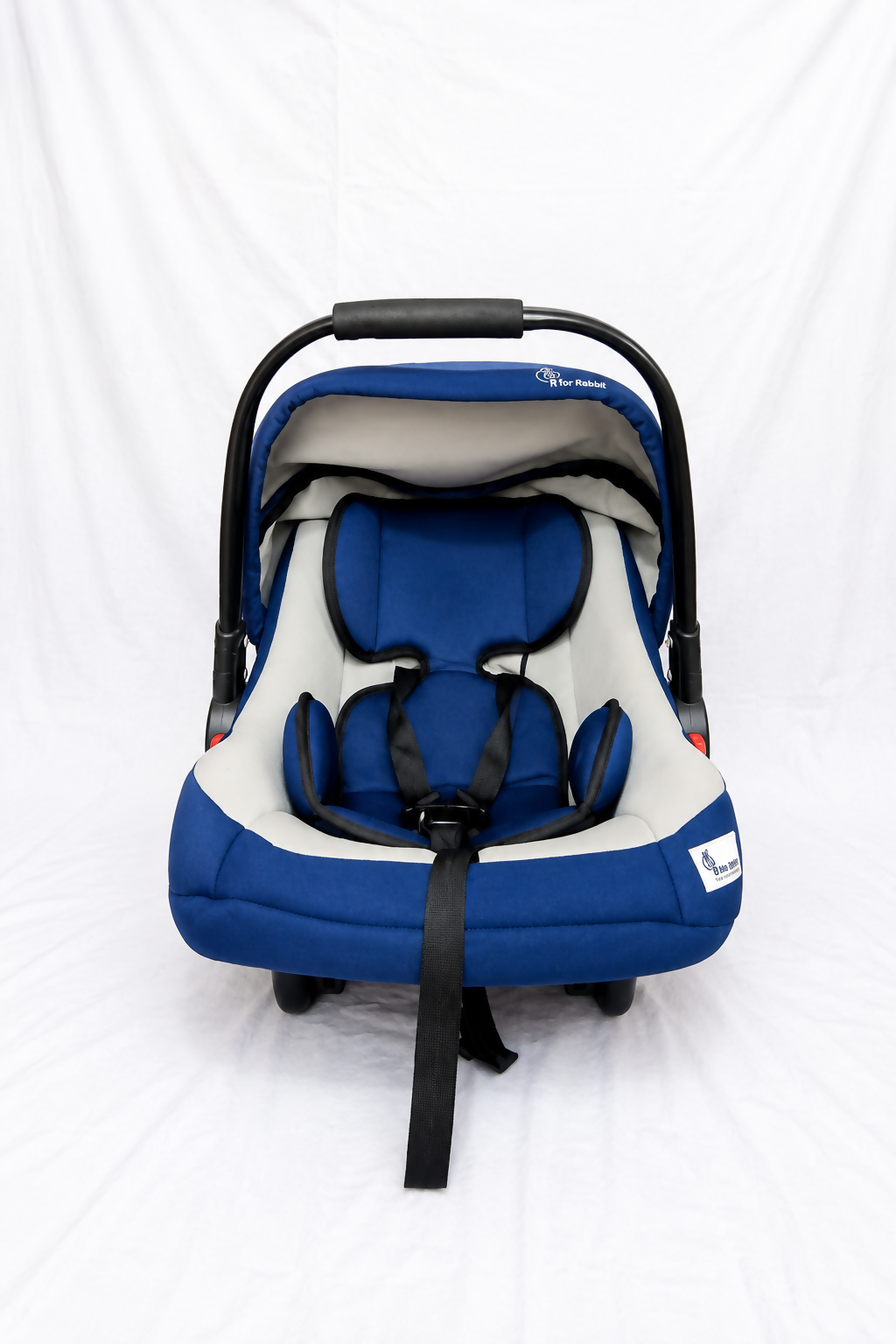 R for Rabbit infant car seat carrier with canopy, cushioned newborn support, secure safety harness, carry handle, and travel cot functionality for safe and comfortable journeys.