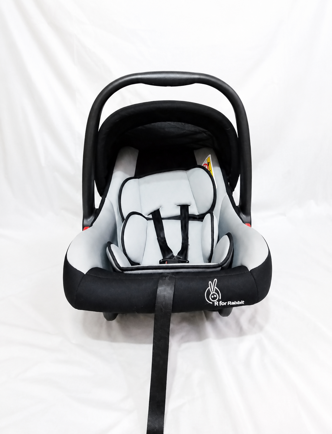 R for Rabbit Picaboo infant car seat carrier with rear-facing design, cushioned newborn support, secure safety harness, carry handle, and comfortable travel protection for babies.