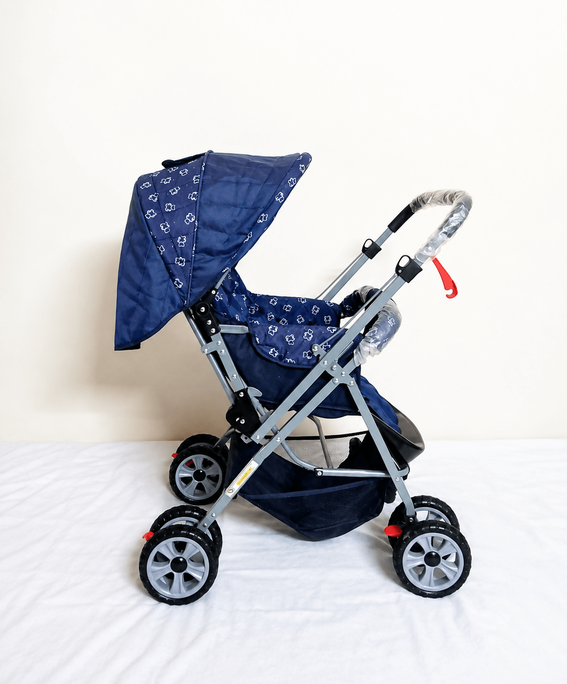 Babyhug Reversible Handle Baby Stroller Pram with mosquito net, reversible handle, reclining seat, foldable frame, 5-point safety harness, adjustable canopy, and storage basket for comfortable travel.