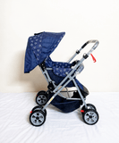 Babyhug Reversible Handle Baby Stroller Pram with mosquito net, reversible handle, reclining seat, foldable frame, 5-point safety harness, adjustable canopy, and storage basket for comfortable travel.