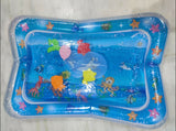 Children's inflatable pool with ocean-themed toys on a light gray background