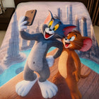 Blanket with cartoon characters taking a selfie on a bed