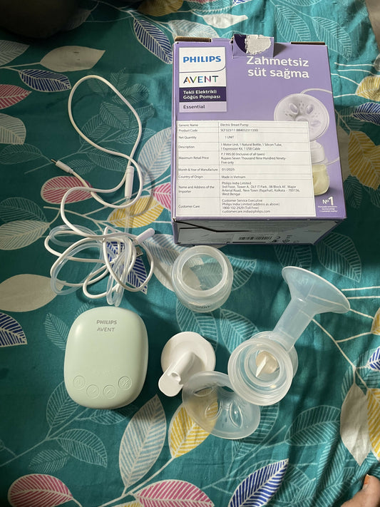 Philips Avent breast pump parts on a patterned fabric background