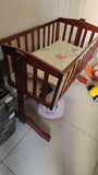 LuvLap wooden cradle with a sturdy wooden frame, gentle rocking motion, protective side rails, and a spacious sleeping area for safe and comfortable rest for newborns and infants.