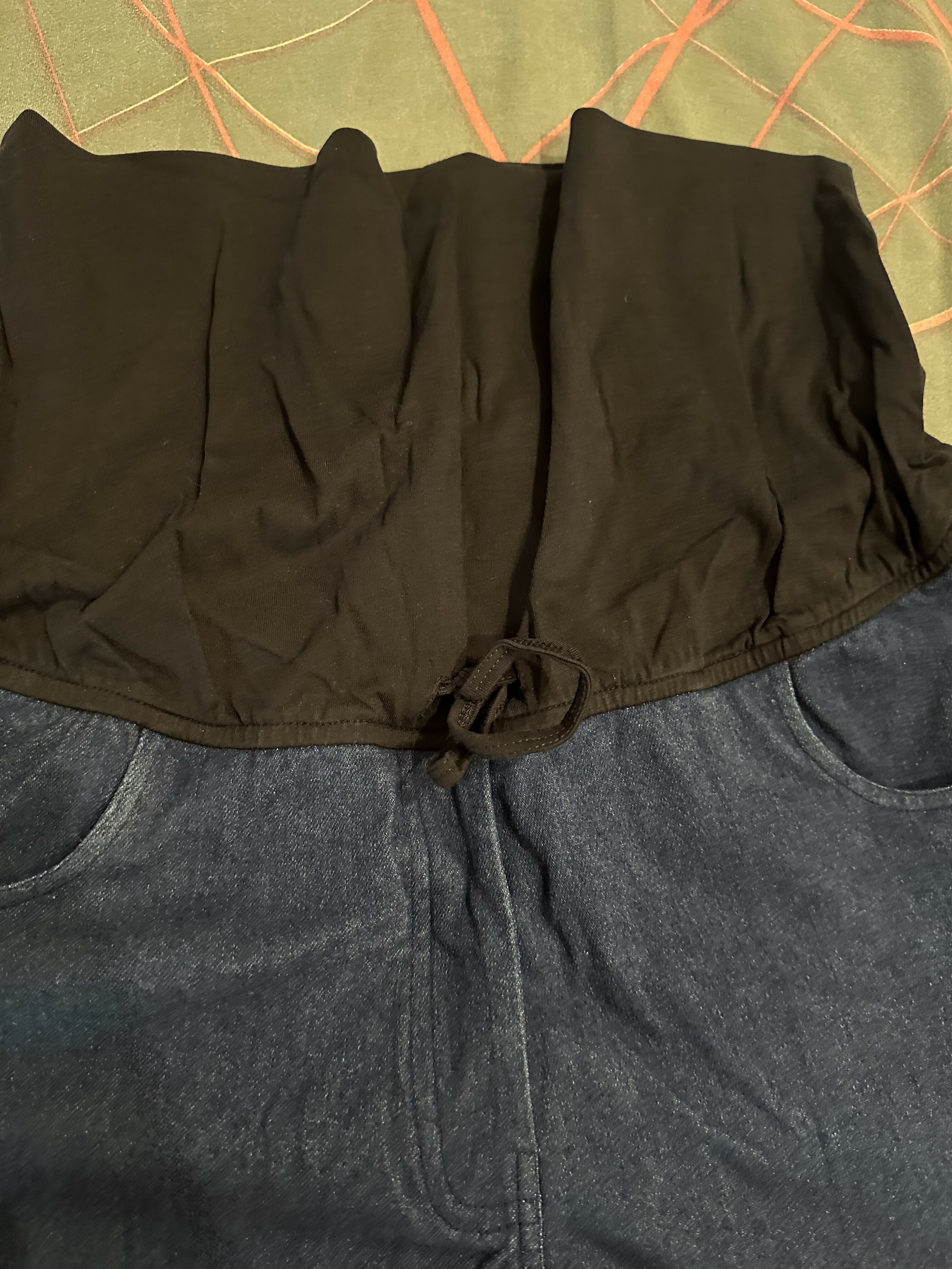 Close-up of a black jacket with a green patterned background