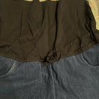 Close-up of a black jacket with a green patterned background