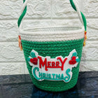 Green woven basket with 'Merry Christmas' 