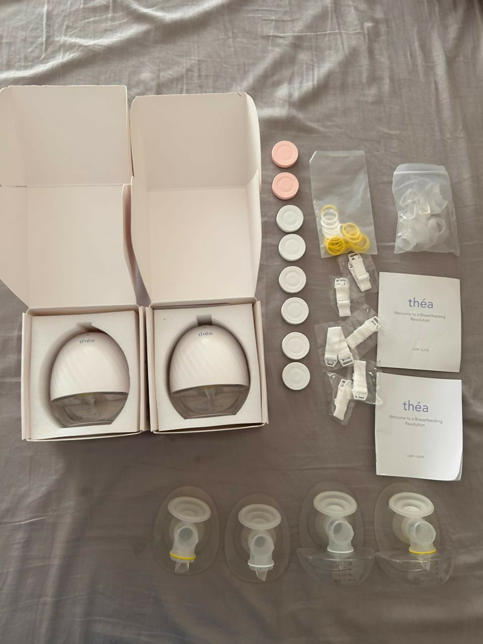 Théa wearable electric breast pump with hands-free design, compact milk collection cups, adjustable suction, and portable pumping support for breastfeeding mothers.