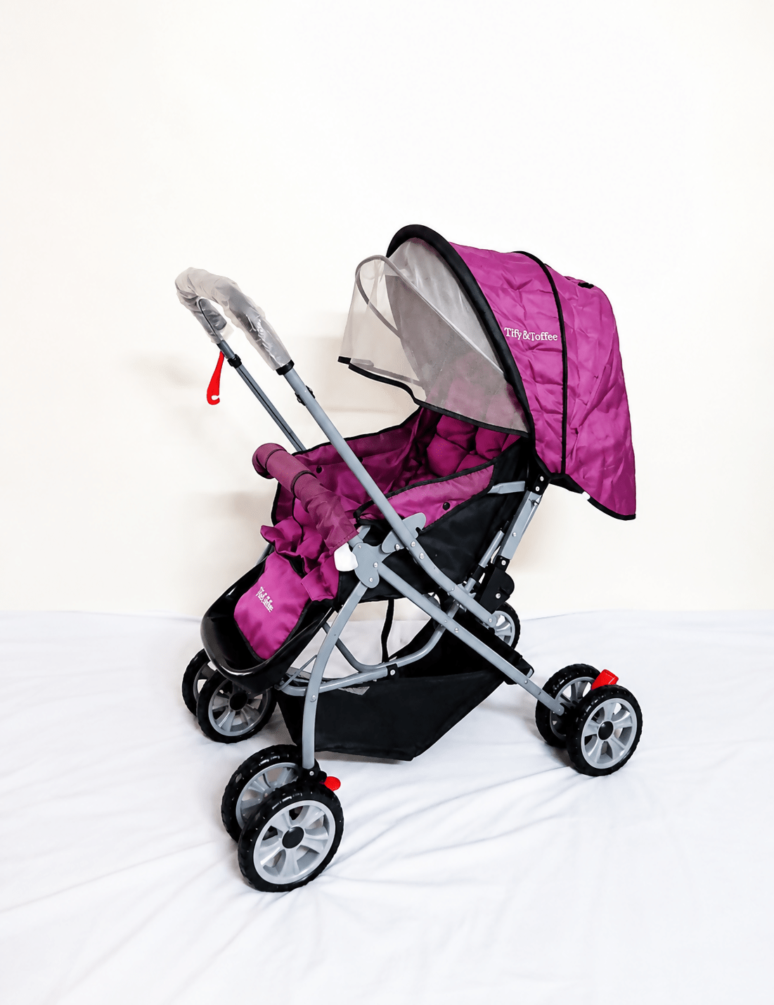 Tiffy & Toffee Maxtrem baby stroller with reversible handle, reclining seat, foldable travel pram design, adjustable canopy, 5-point safety harness, smooth wheels, and storage basket for babies and toddlers up to 22 kg.