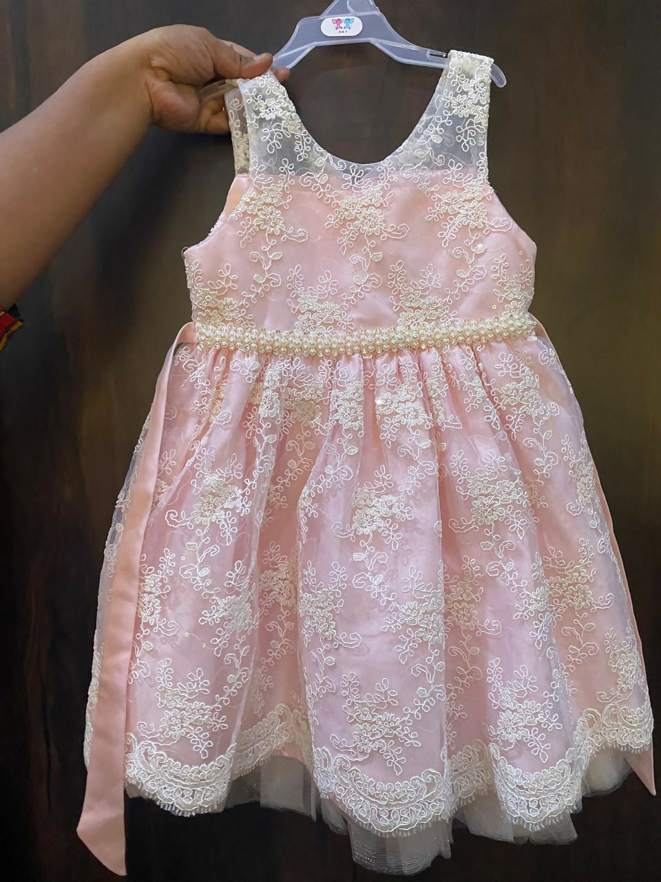 Adorn your baby girl in this elegant Pearl and Lace Work Frock, perfect for making precious memories!






