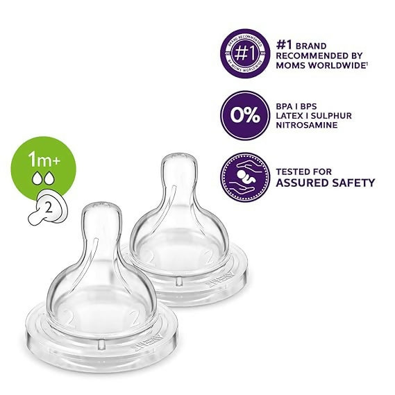 Two clear baby bottle nipples with safety certification logos on a white background
