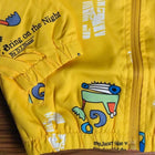 Yellow jacket with cartoon designs and text 