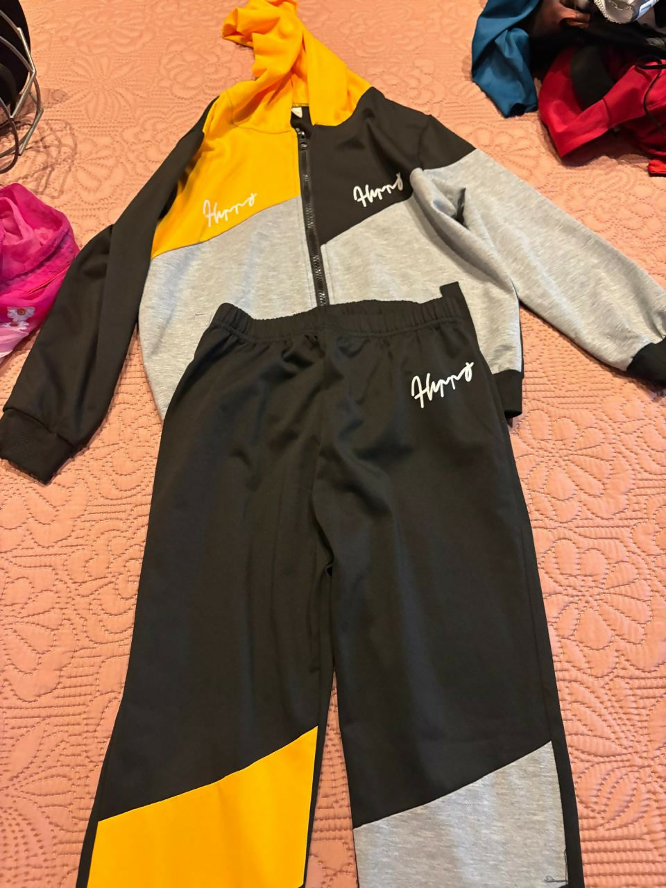Unisex tracksuit set with comfortable fabric, coordinated top and bottom design, relaxed fit, and versatile style for everyday wear, outdoor activities, and active play.