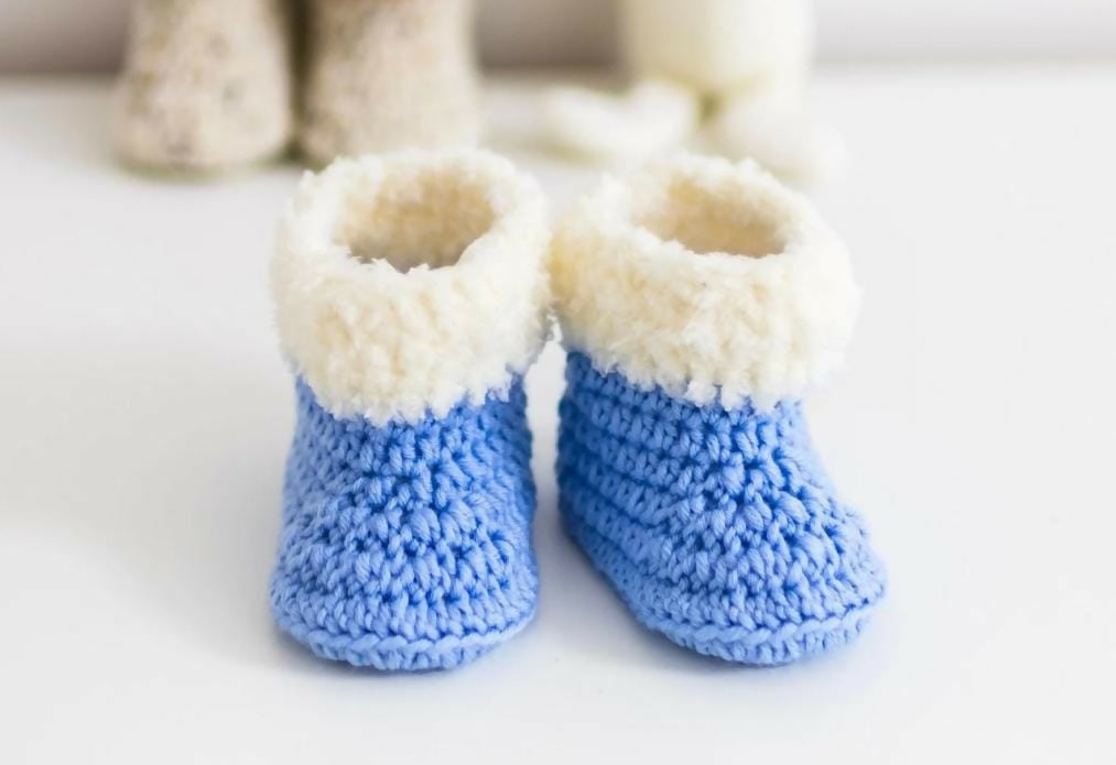 Handmade baby booties and beanie set, customizable with premium yarn for warmth, comfort, and a personal touch.