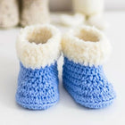 Handmade baby booties and beanie set, customizable with premium yarn for warmth, comfort, and a personal touch.