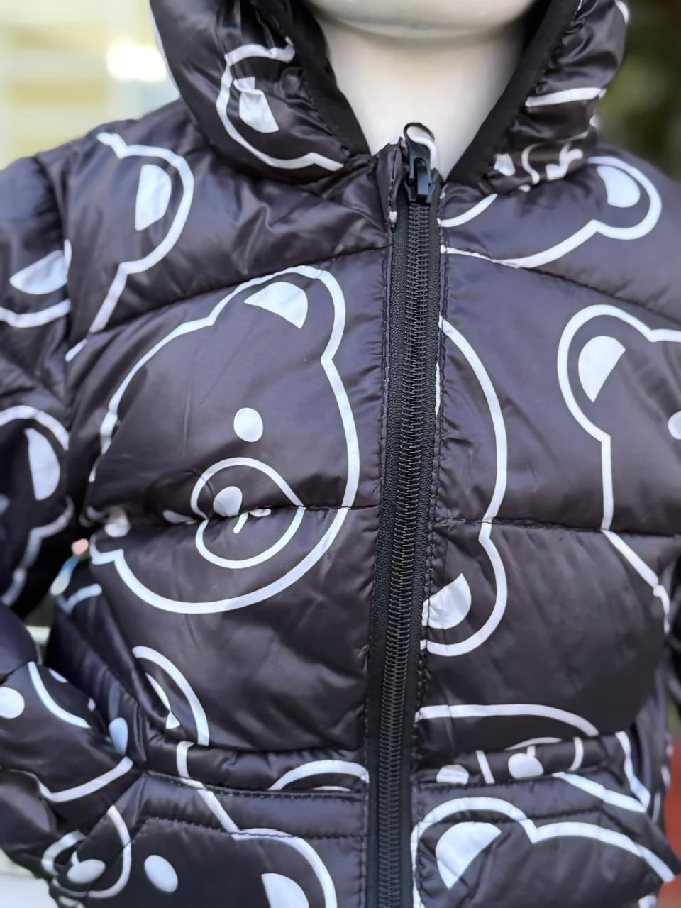 Black puffer jacket with white bear patterns 