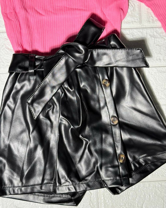 Black leather skirt with buttons and a pink top 