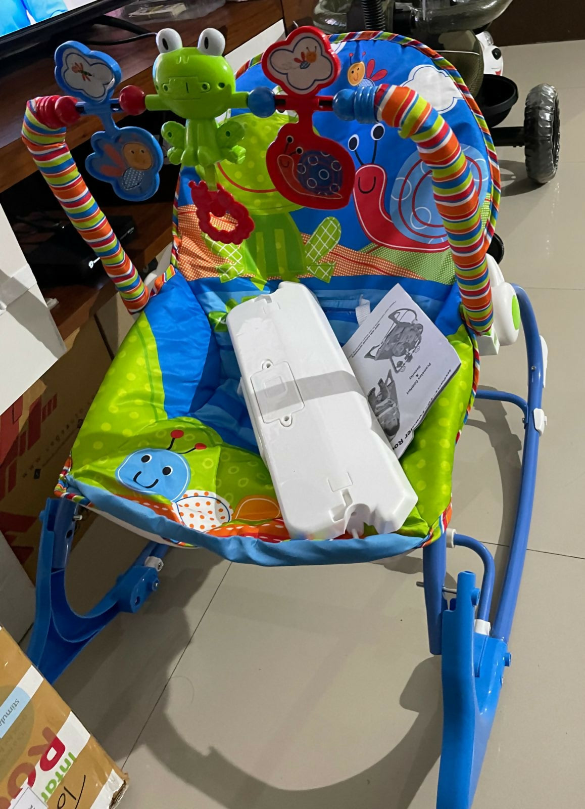 Discover THE LITTLE LOOKERS Infant-To-Toddler Rocker with Music and Vibration, featuring an ergonomic design, adjustable reclining positions, and a detachable toy bar for comfort and engagement from infancy to toddlerhood.