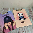 Two clipboards with personalized designs on a wooden surface