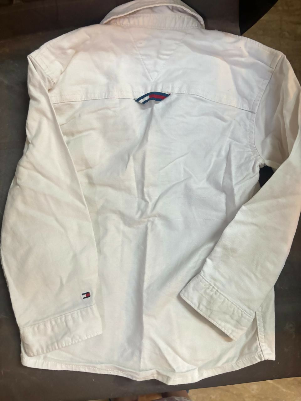 TOMMY HILFIGER white shirt featuring soft comfortable fabric, classic collar design, button-down styling, and a versatile look suitable for casual and formal occasions.