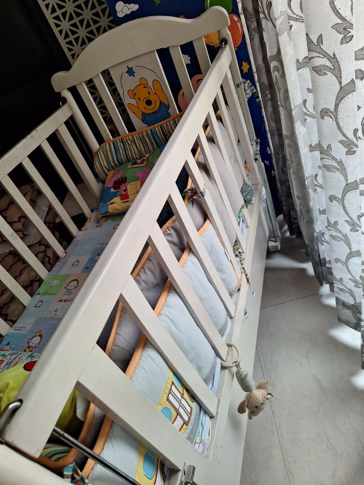 Wooden baby crib with storage, mattress, and bumper featuring sturdy wooden construction, spacious sleeping area, built-in storage, protective bumpers, and comfortable support for babies.